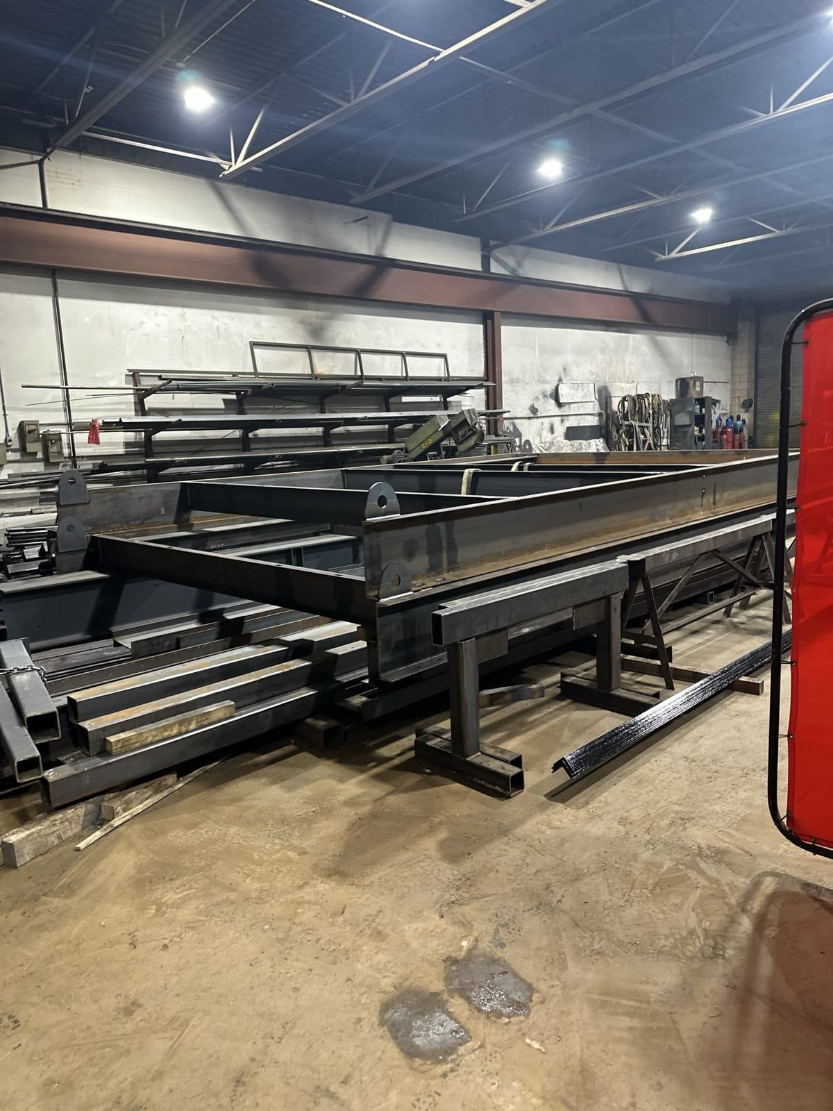 Steel stock and fabricated frames staged in the SiloTech shop